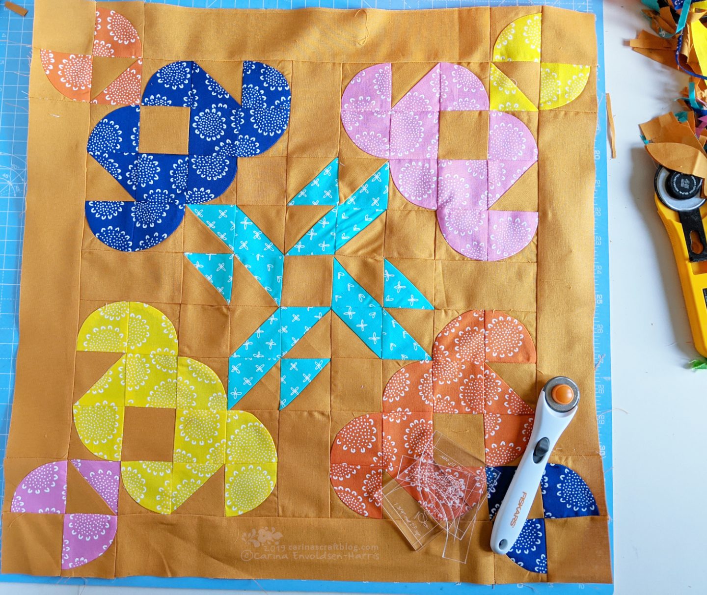 Mini quilt top with four stylized tulips.