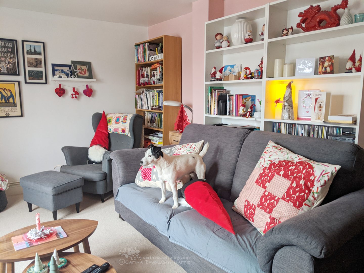 Dog standing on sofa, cushions falling all over the place.