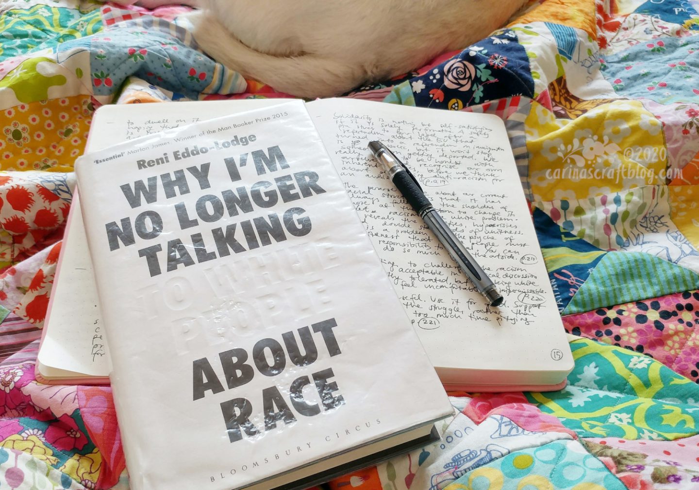 Book Why I'm No Longer Talking to White People About Race on top of open notebook