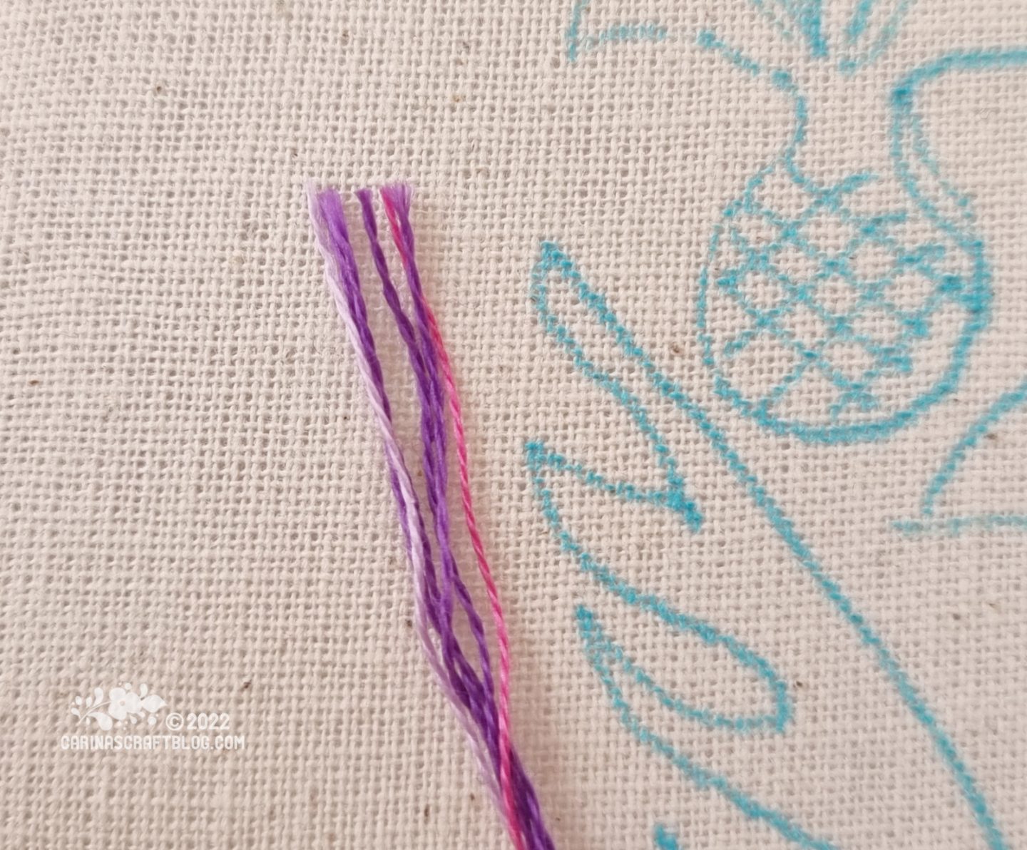 Closeup of the end of a bunch of thread strands in purple and lilac colours.