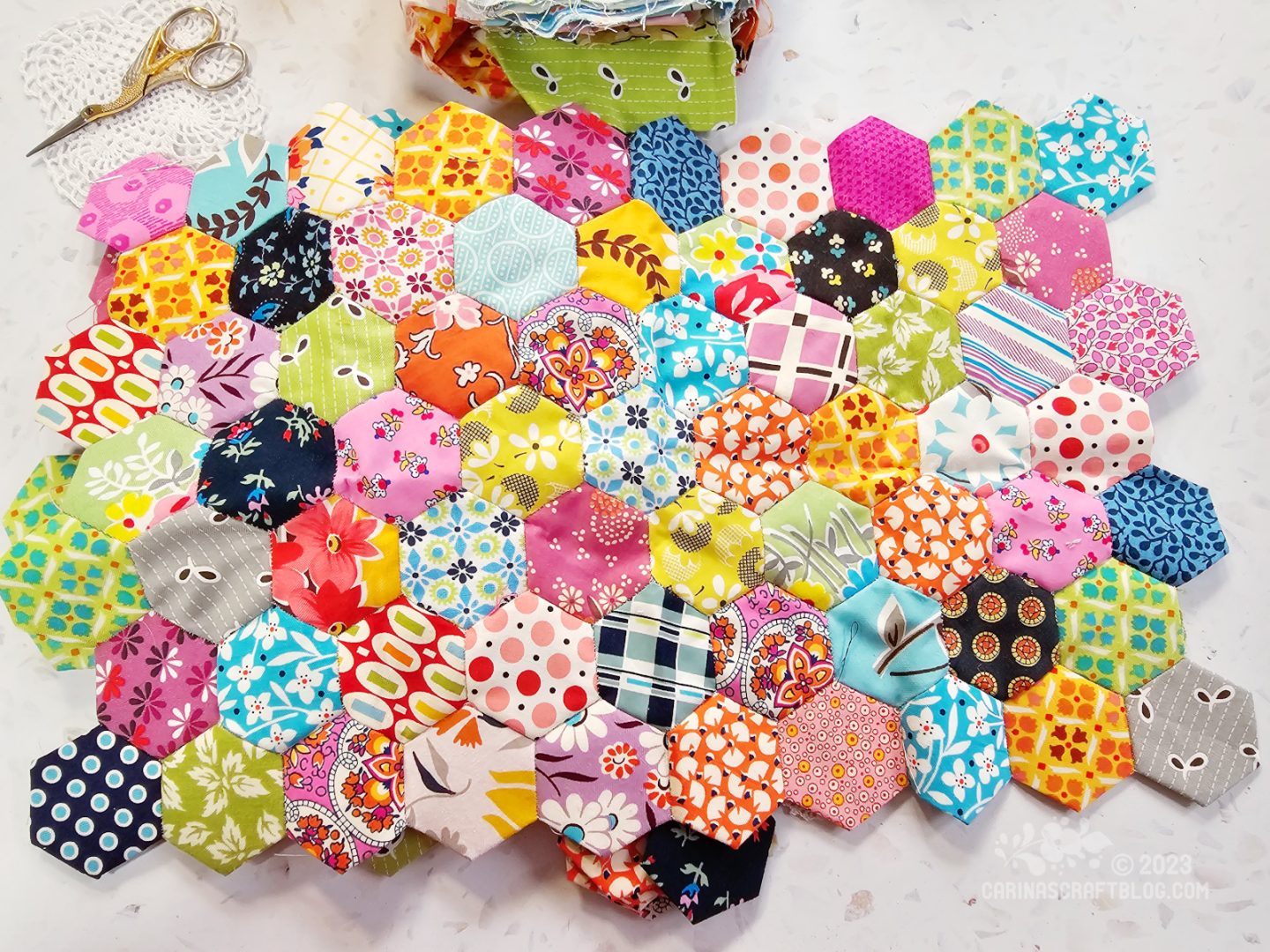 Overhead view of fabric hexagons sewn together in a rectangle shape.